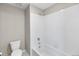 A clean and bright bathroom features a tub with white tiling and a modern toilet at 4851 Cattle Cross Rd, Castle Rock, CO 80104