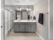 Modern bathroom with double vanity, framed mirrors and large glass-enclosed shower at 4851 Cattle Cross Rd, Castle Rock, CO 80104