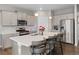 Stylish kitchen with white countertops, stainless steel appliances, and a central island with barstools at 4851 Cattle Cross Rd, Castle Rock, CO 80104