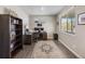 Spacious home office with a large desk, bookshelves, and ample natural light at 4851 Cattle Cross Rd, Castle Rock, CO 80104