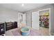 Spacious carpeted playroom with organized walk-in closet and room for to play at 4851 Cattle Cross Rd, Castle Rock, CO 80104