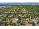 An aerial view showcasing the neighborhood, with its mature trees, and distant city and mountain views at 521 Harrison St, Denver, CO 80206