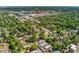An aerial view shows mature trees throughout the neighborhood with the city in the background at 521 Harrison St, Denver, CO 80206