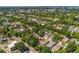 An aerial view of the property nestled in a neighborhood surrounded by mature trees and city views at 521 Harrison St, Denver, CO 80206