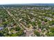 An aerial view of the neighborhood features mature trees with the city and mountains in the background at 521 Harrison St, Denver, CO 80206