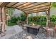 A charming backyard with a gazebo, fire pit, lush greenery, and vibrant flowers at 521 Harrison St, Denver, CO 80206
