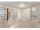 Basement room featuring neutral carpet, built-in bookshelves, and access to additional spaces at 521 Harrison St, Denver, CO 80206