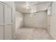 Unfinished basement space featuring neutral carpeting, a window, and storage at 521 Harrison St, Denver, CO 80206