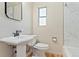 Traditional bathroom featuring white pedestal sink and marble tiled shower at 521 Harrison St, Denver, CO 80206