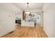 Open dining space with hardwood floors flowing into the kitchen area at 521 Harrison St, Denver, CO 80206