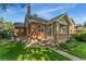 A charming brick home with a well-manicured lawn and inviting front entrance porch at 521 Harrison St, Denver, CO 80206