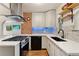 Updated kitchen featuring stainless steel appliances, brick accent wall, and white countertops at 521 Harrison St, Denver, CO 80206
