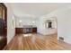 Spacious living room featuring hardwood floors, fireplace, and an archway to the kitchen at 521 Harrison St, Denver, CO 80206