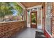 Enclosed front porch featuring a brick wall, frosted glass, and view of the neighborhood at 521 Harrison St, Denver, CO 80206
