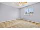 Well-lit bedroom with neutral walls and carpet at 4072 S Kirk Way, Aurora, CO 80013