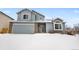 Two-story house with attached garage, snow-covered lawn and brick accents at 4072 S Kirk Way, Aurora, CO 80013