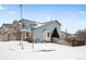 Two-story house with gray siding, visible street address and snowy yard at 4072 S Kirk Way, Aurora, CO 80013