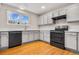 Kitchen with gray cabinets, modern appliances, and wood flooring at 4072 S Kirk Way, Aurora, CO 80013