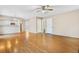 Living room with hardwood floors, ceiling fan, and access to the kitchen at 4072 S Kirk Way, Aurora, CO 80013