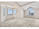 Living room with large windows, vaulted ceiling, and neutral colored walls at 4072 S Kirk Way, Aurora, CO 80013