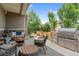 Relaxing backyard patio with comfortable seating, a fire pit, outdoor kitchen and lush landscaping at 10182 Bristleridge St, Parker, CO 80134