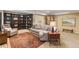 Finished basement with custom shelving, neutral walls, media center and comfortable seating at 10182 Bristleridge St, Parker, CO 80134