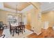 Formal dining room features beautiful hardwood floors and a classic chandelier, perfect for Gathering dinners at 10182 Bristleridge St, Parker, CO 80134