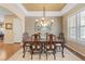 Elegant dining room with hardwood floors, decorative chandelier, and a large window for natural light at 10182 Bristleridge St, Parker, CO 80134