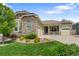 Charming home with a stone and siding exterior, well-manicured lawn, and a three-car garage at 10182 Bristleridge St, Parker, CO 80134