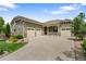 Attractive home with a three-car garage and large concrete driveway on a sunny day at 10182 Bristleridge St, Parker, CO 80134