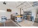 Organized garage space with storage cabinets, worktable, TV, and finished flooring at 10182 Bristleridge St, Parker, CO 80134