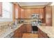Functional kitchen featuring granite countertops, stainless steel appliances, and ample cabinet space at 10182 Bristleridge St, Parker, CO 80134