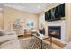 Comfortable living room featuring a fireplace, hardwood floors, and stylish decor at 10182 Bristleridge St, Parker, CO 80134