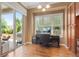 Bright home office featuring hardwood floors, a large window, and a sliding door to the backyard at 10182 Bristleridge St, Parker, CO 80134