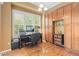 Bright home office with large window, built-in shelving, and hardwood floors at 10182 Bristleridge St, Parker, CO 80134