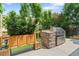 Outdoor kitchen features a stainless steel grill, brick surround, and greenery, perfect for entertaining at 10182 Bristleridge St, Parker, CO 80134