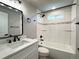 Bright bathroom features modern fixtures, shower/tub combo, and tiled walls at 10025 W 8Th Ave, Lakewood, CO 80215