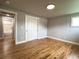 Spacious bedroom with hardwood floors, closet, bathroom access, and fresh paint at 10025 W 8Th Ave, Lakewood, CO 80215