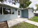 Close up of the front exterior of the home featuring blue siding and a white front door at 10025 W 8Th Ave, Lakewood, CO 80215
