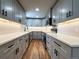 Modern kitchen with stylish gray cabinets, stainless steel appliances, and sleek countertops at 10025 W 8Th Ave, Lakewood, CO 80215