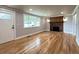 Inviting living room featuring beautiful hardwood floors and a cozy brick fireplace with a wooden mantle at 10025 W 8Th Ave, Lakewood, CO 80215