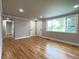 Bright living room with hardwood floors, gray walls, and large windows providing plenty of natural light at 10025 W 8Th Ave, Lakewood, CO 80215
