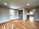 Cozy living room and laundry area with hardwood floors leading to the kitchen at 10025 W 8Th Ave, Lakewood, CO 80215