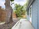A side yard boasts a big tree and an access door at 10025 W 8Th Ave, Lakewood, CO 80215