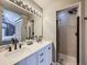 Modern bathroom with double vanity and walk-in shower at 4737 N Bearlily Way, Castle Rock, CO 80109