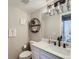 Updated bathroom with white vanity, modern fixtures, and floating shelves at 4737 N Bearlily Way, Castle Rock, CO 80109