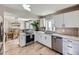 Updated kitchen with white cabinets, stainless steel appliances, and quartz countertops at 4737 N Bearlily Way, Castle Rock, CO 80109