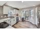 Modern kitchen with white cabinets, stainless steel appliances, and light flooring at 4737 N Bearlily Way, Castle Rock, CO 80109