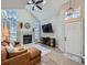 Spacious living room with vaulted ceiling, fireplace, and hardwood floors at 4737 N Bearlily Way, Castle Rock, CO 80109