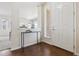 Bright foyer with hardwood floors, a modern console table, and views into the living area at 7367 S Pennsylvania St, Littleton, CO 80122